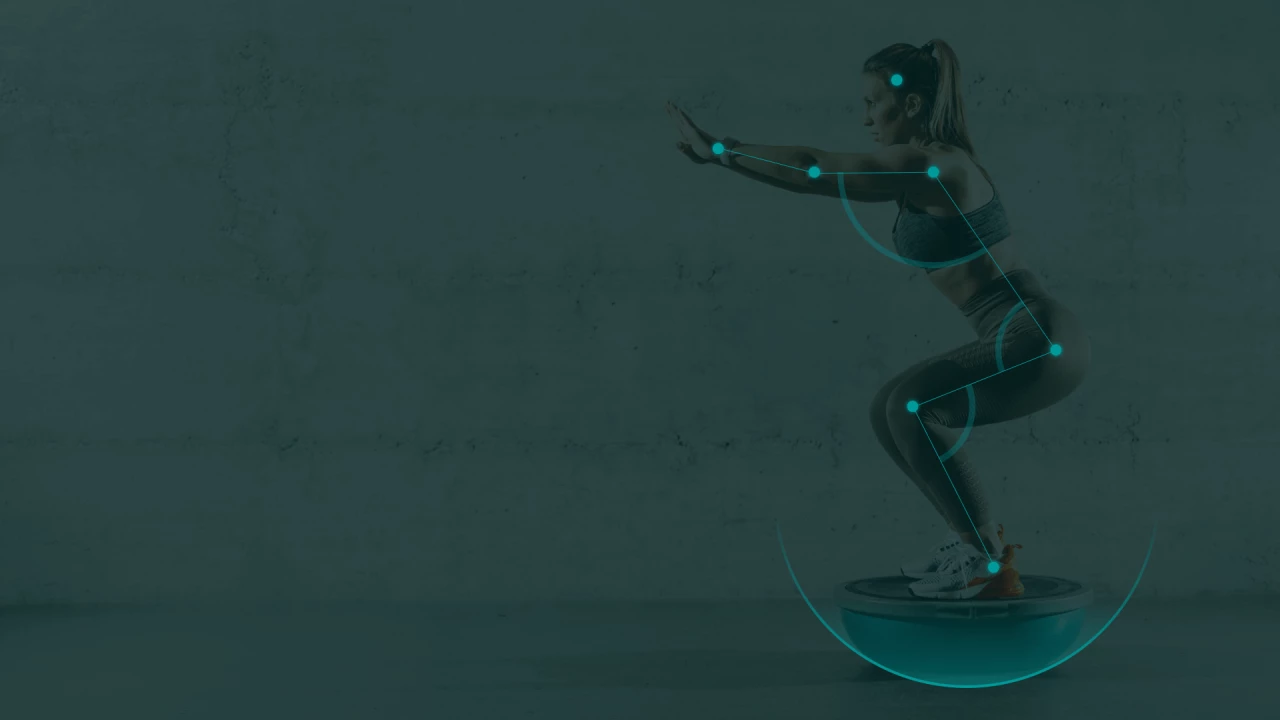 female athlete standing on a balance trainer while having her movement tracked